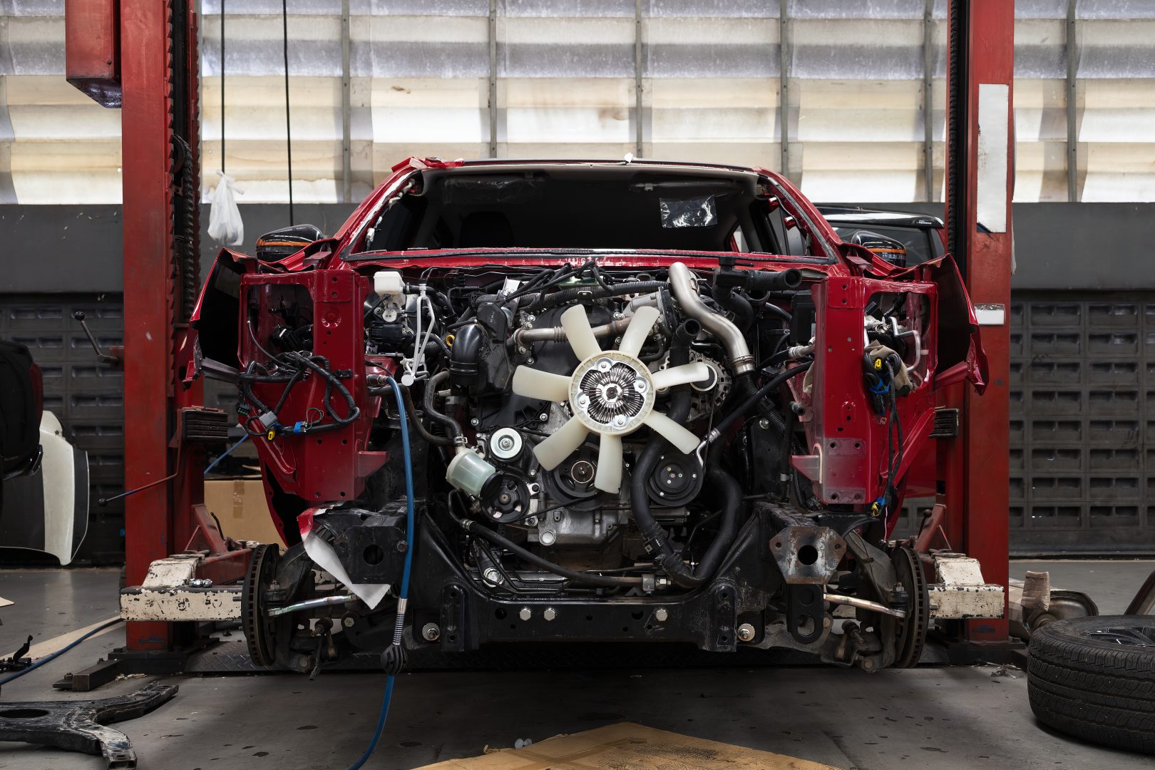Red,Car,In,Automobile,Repair,Service,Center,With,Soft-focus,And